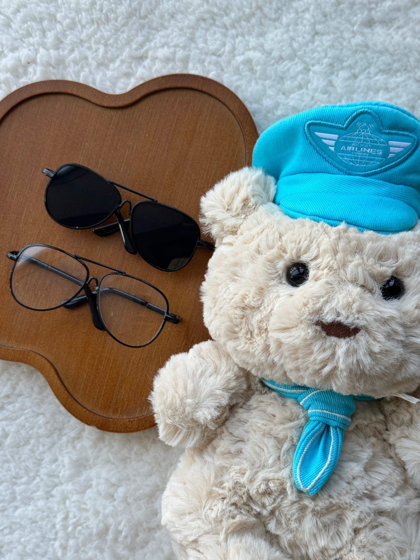 Cute pilot-style glasses for Jellycat bear plush on cream blanket