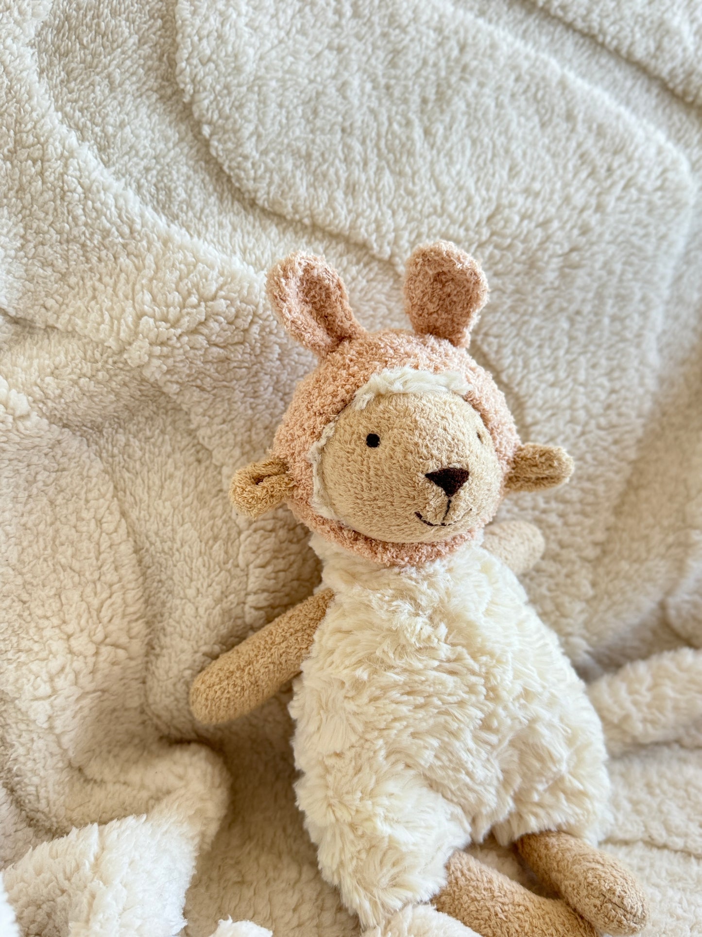 Side view of Lottie Lamb in the cream hat, showing ear shape and texture.
