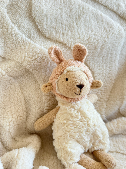 Side view of Lottie Lamb in the cream hat, showing ear shape and texture.