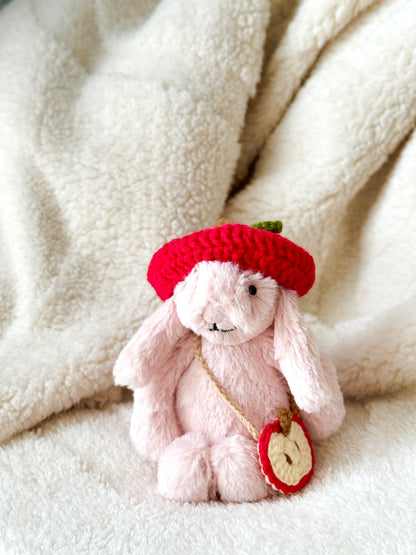 Jellycat pink bunny wearing handmade crochet apple hat and apple slice crossbody bag