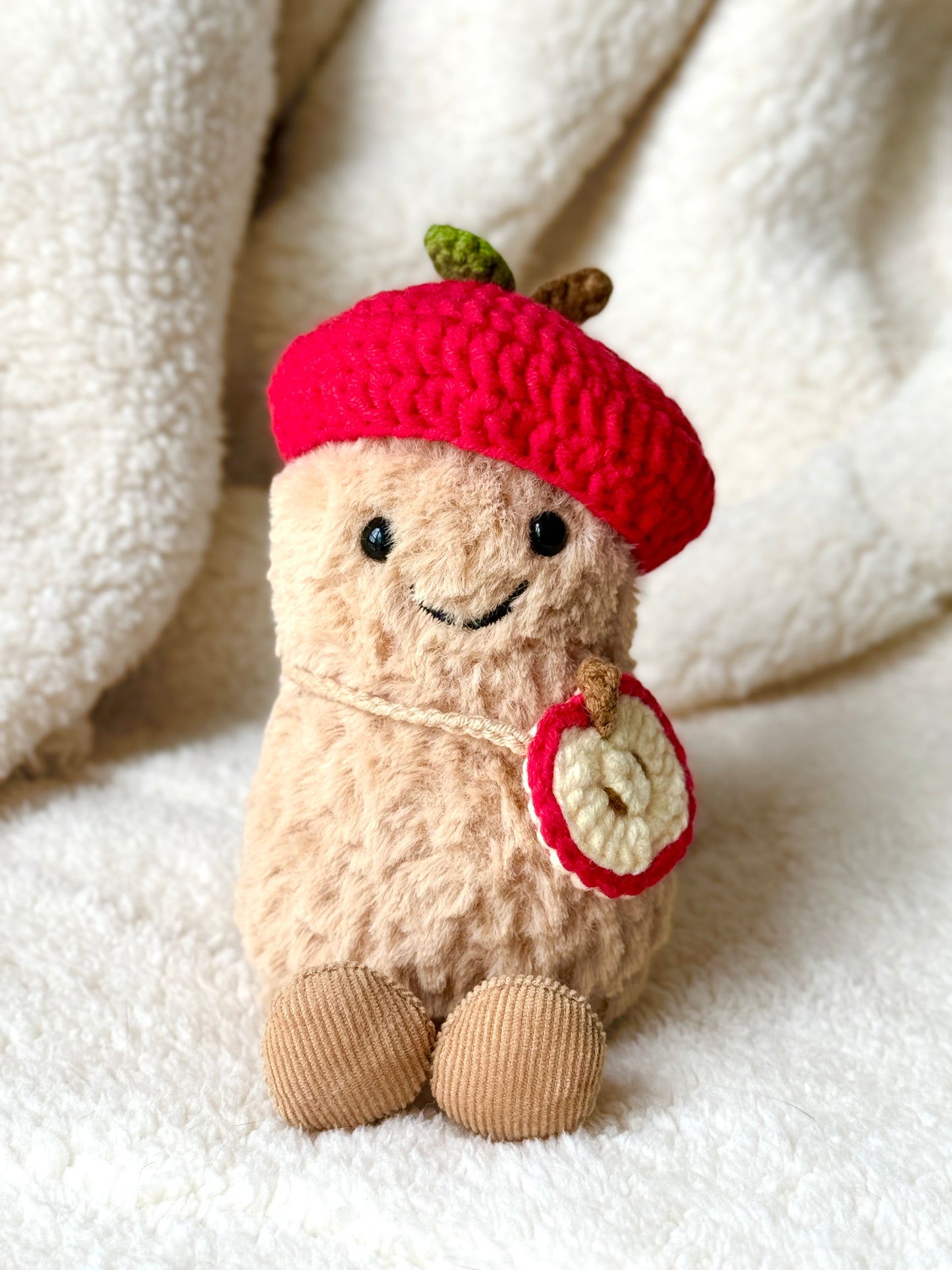 Jellycat Amuseable peanut wearing handmade crochet apple hat and apple slice crossbody bag