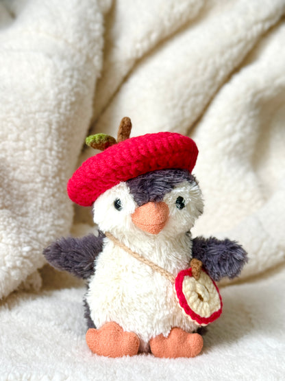 Jellycat penguin wearing handmade crochet apple hat and apple slice crossbody bag