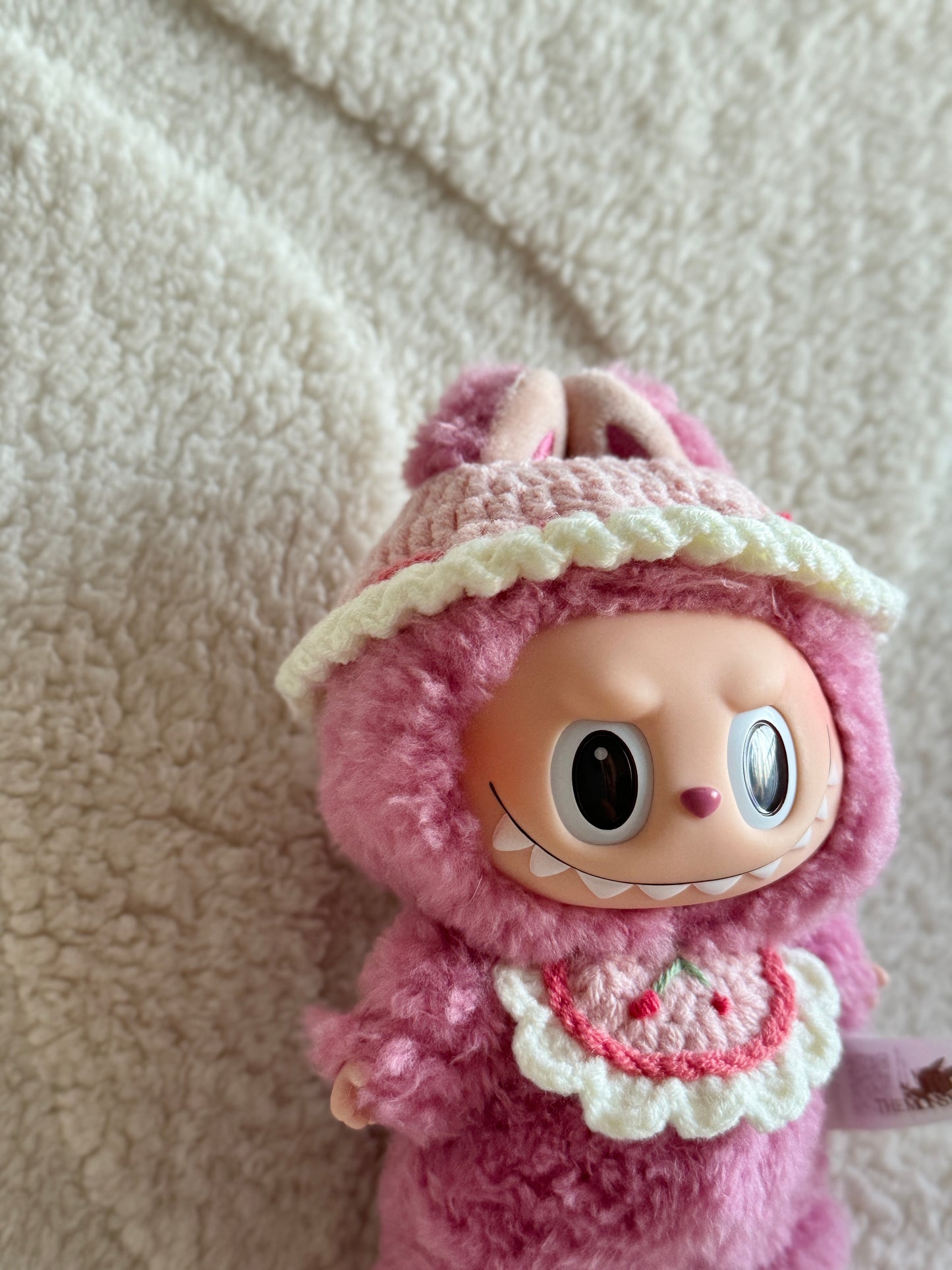 Side angle of the bonnet showing Labubu meimei's ears and scalloped edging.

