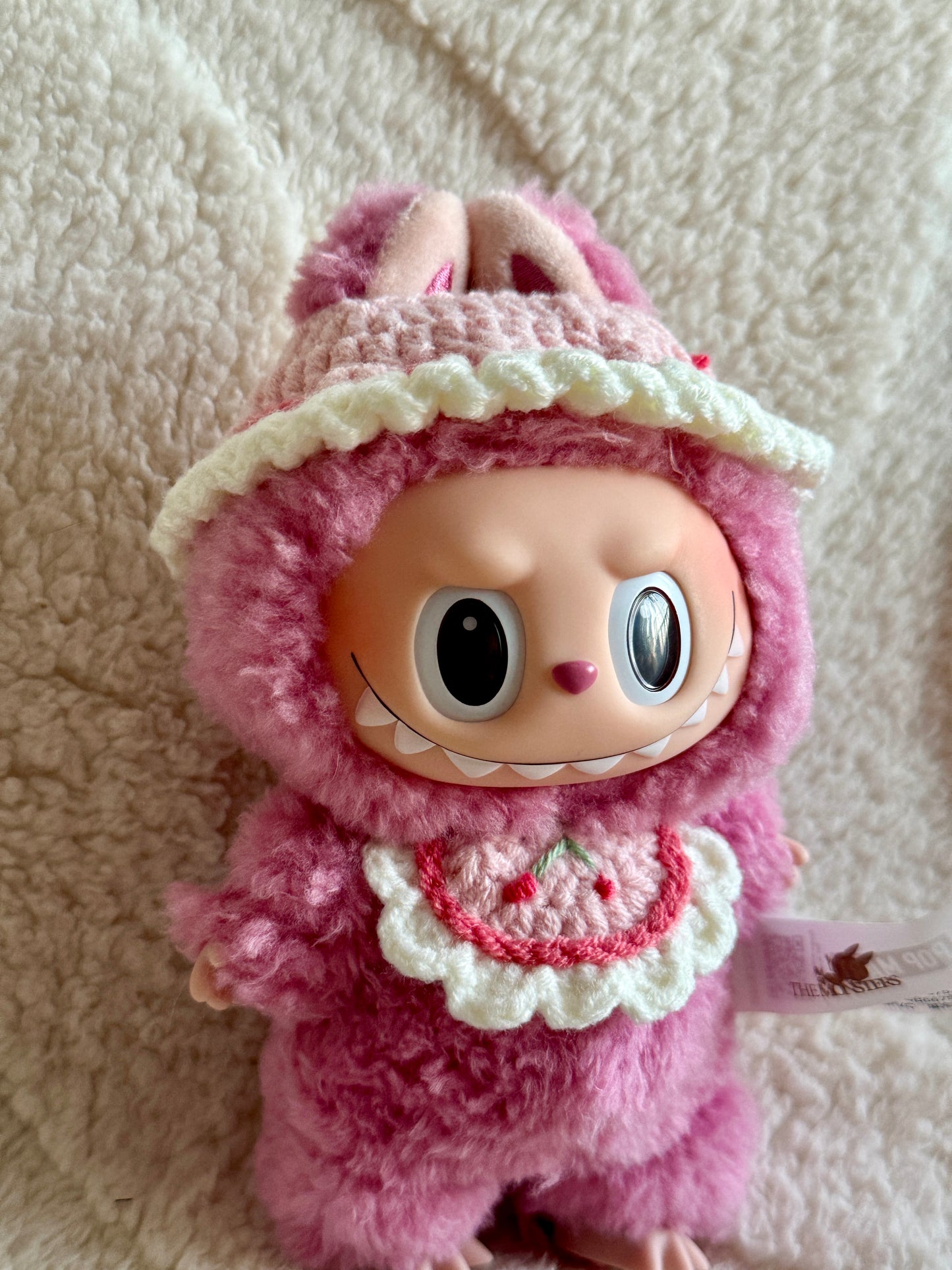 Front angle showing the hand-embroidered cherry on the bib.