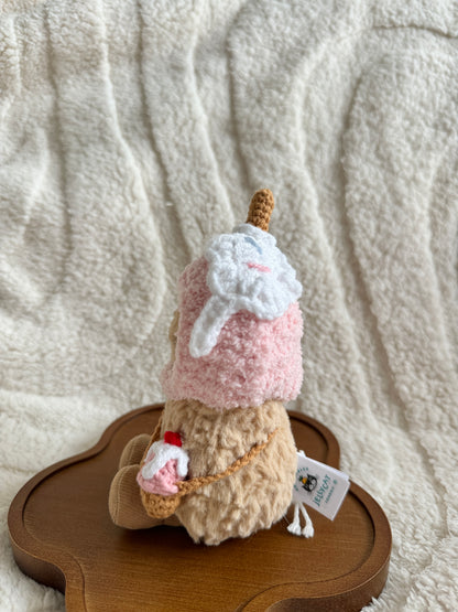 Side view of Jellycat Peanut showing detailed back of the crochet ice cream hat and sling bag.