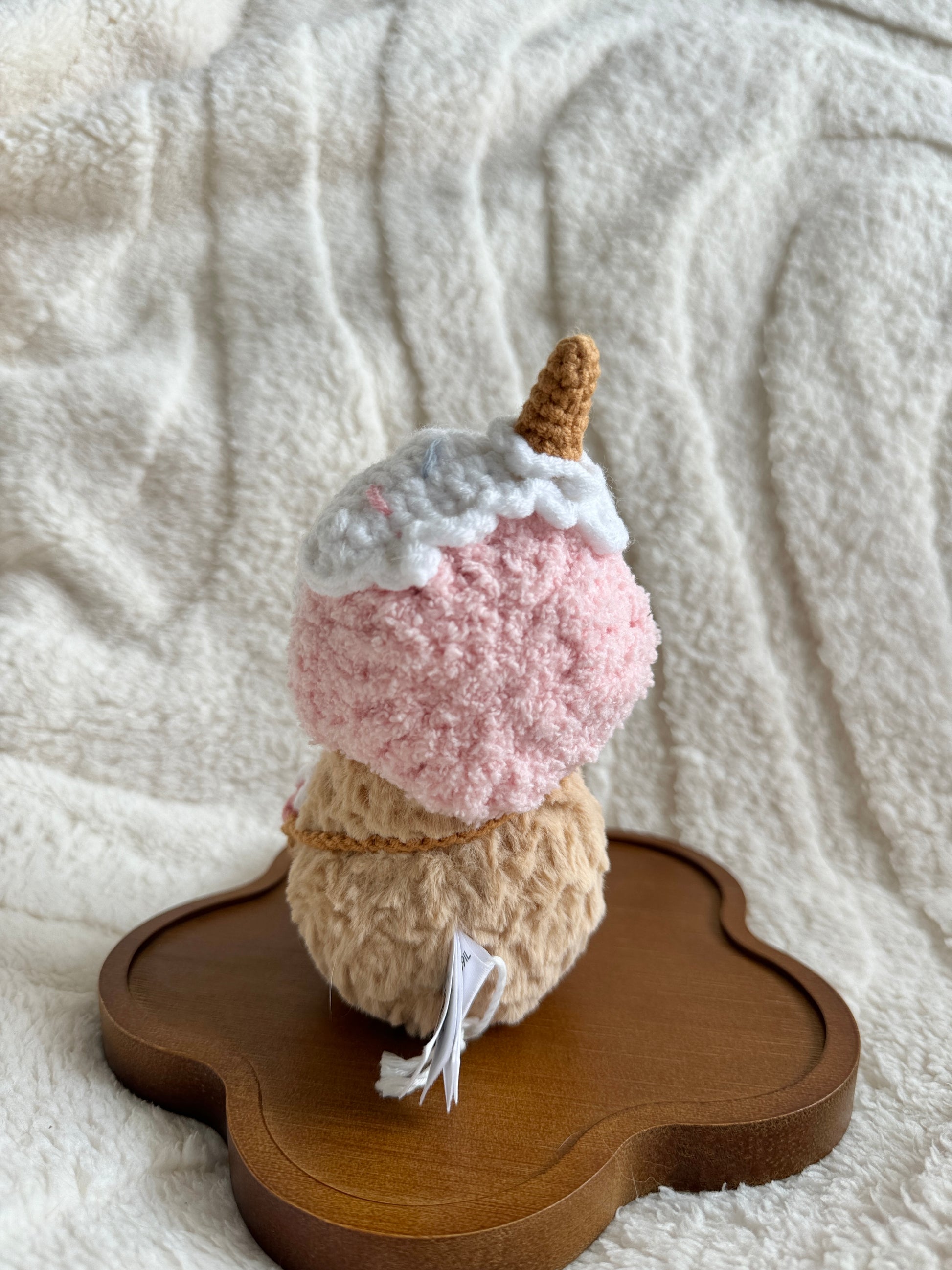 Rear view of the plush with ice cream cone hat and full back of bag visible.