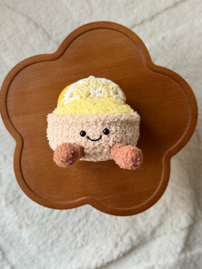 Overhead view showing the full shape of the tart plush, including the detailed lemon wedge topper