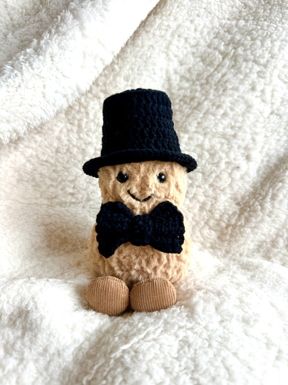Crochet magician outfit set displayed: black top hat and bow tie for Jellycat Peanut.
