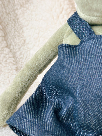 Close up detail of handmade denim overalls for Jellycat Fergus Frog plush toy