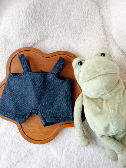 Handmade denim overalls outfit for Jellycat Fergus Frog plush displayed with frog toy