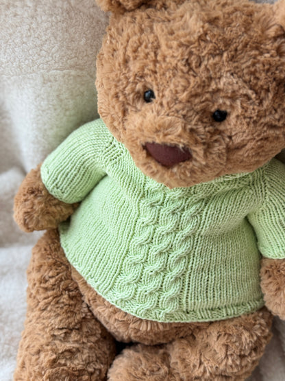 Jellycat Bartholomew Bear in a handmade green knit sweater with classic cable texture and a soft high-neck design.