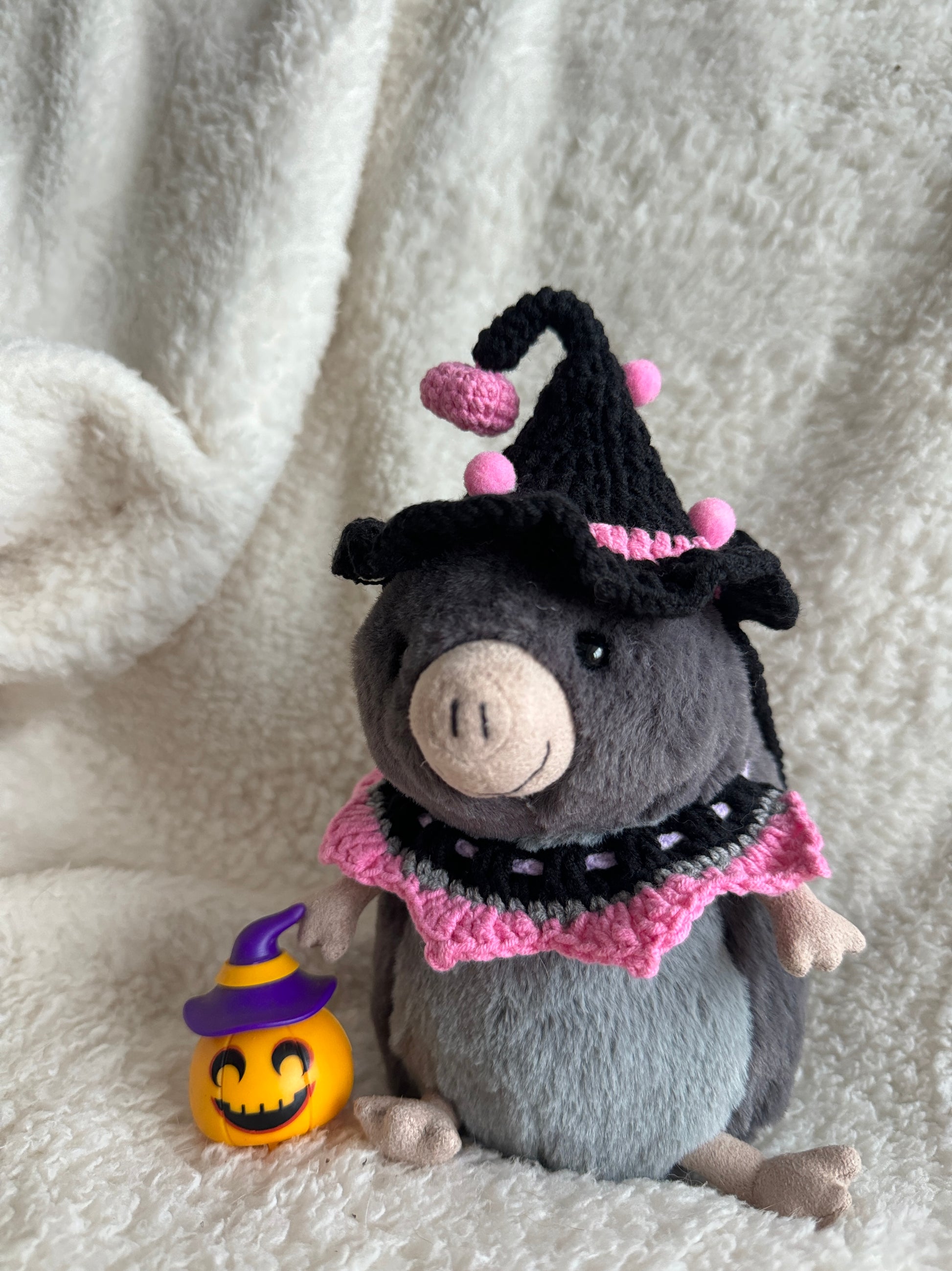 Jellycat Lolly the Sugar Glider wearing handmade black and pink witch costume with pumpkin prop