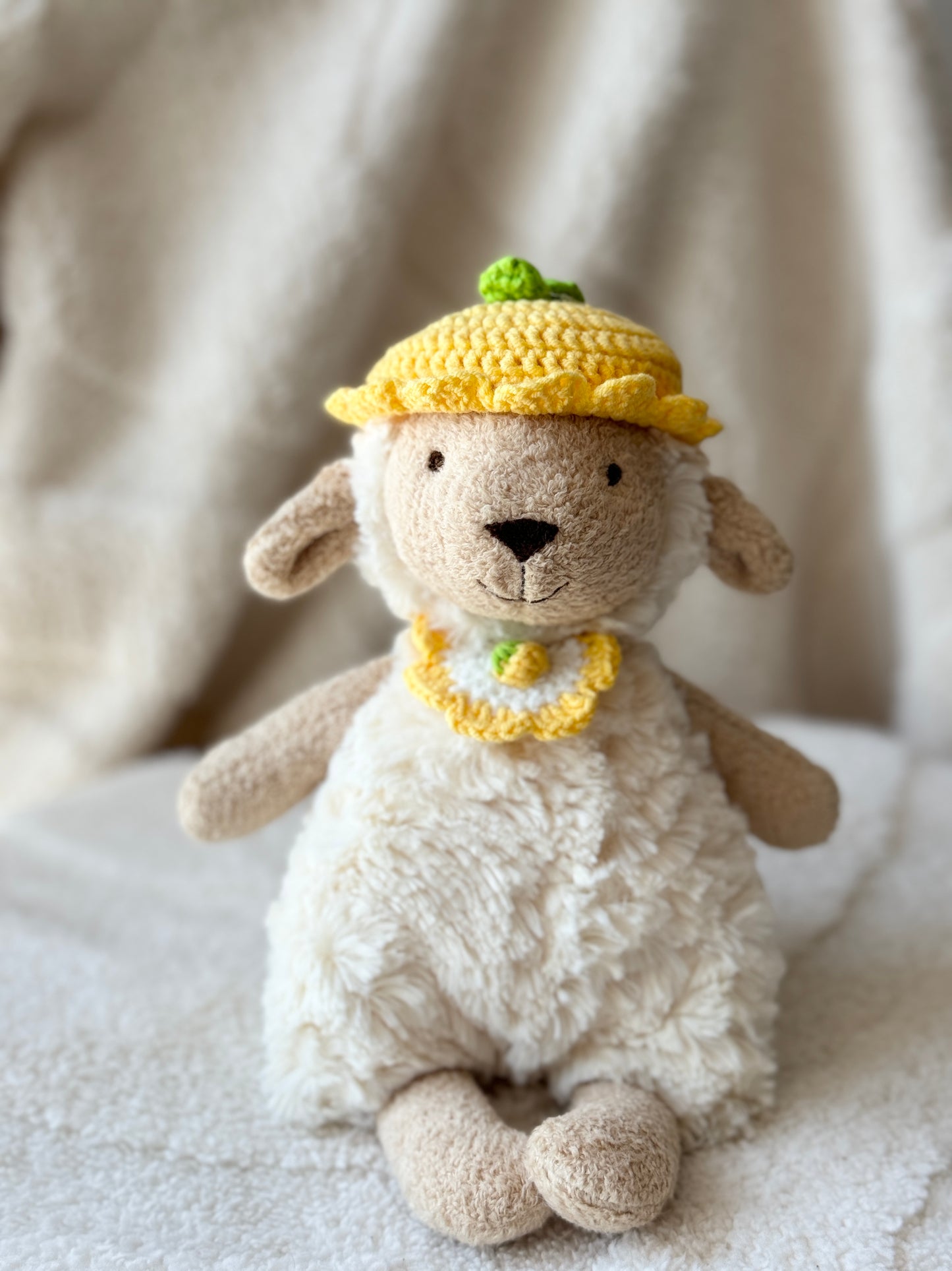 Jellycat Lollie Lamb wearing handmade yellow crochet lemon hat and matching bib outfit