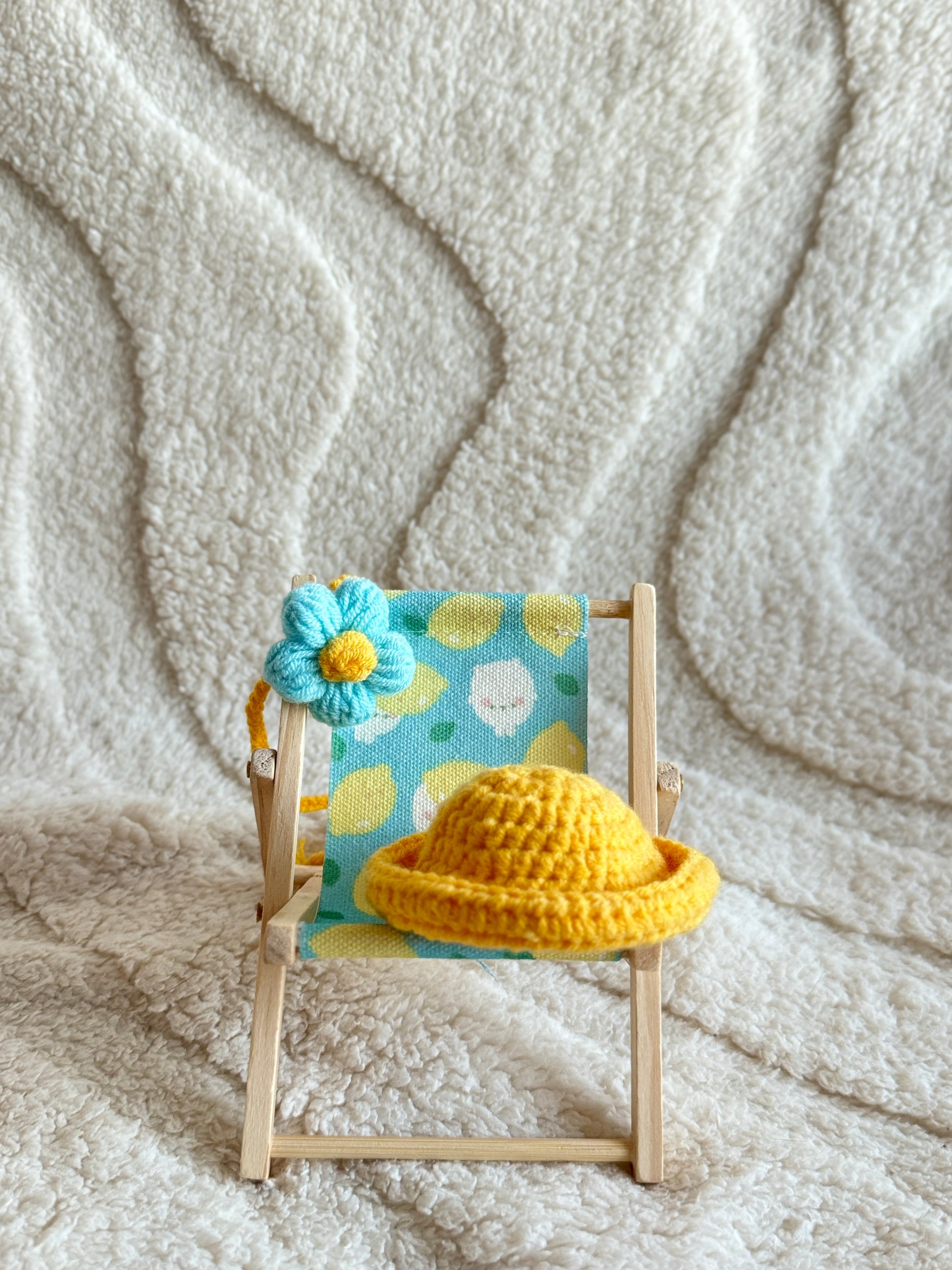 Close-up of outfit displayed on chair with lemon-printed fabric.

