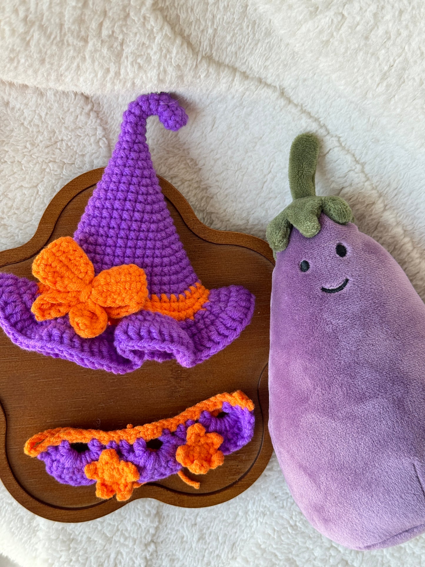 Jellycat Amuseable aubergine styled with violet witch hat and pumpkin-orange star collar.
