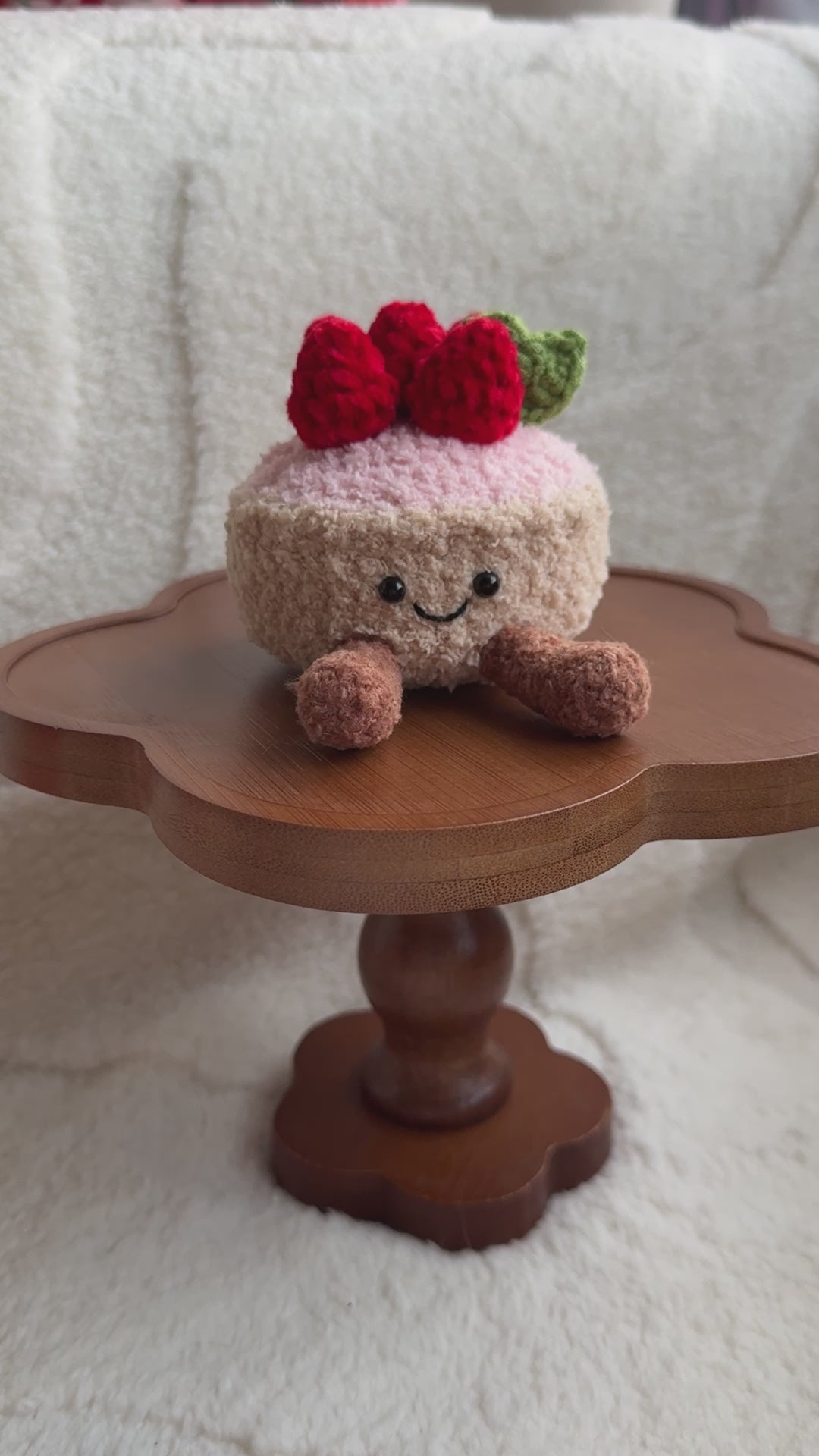 Front view of smiling crochet strawberry tart plush inspired by Jellycat Amuseables.